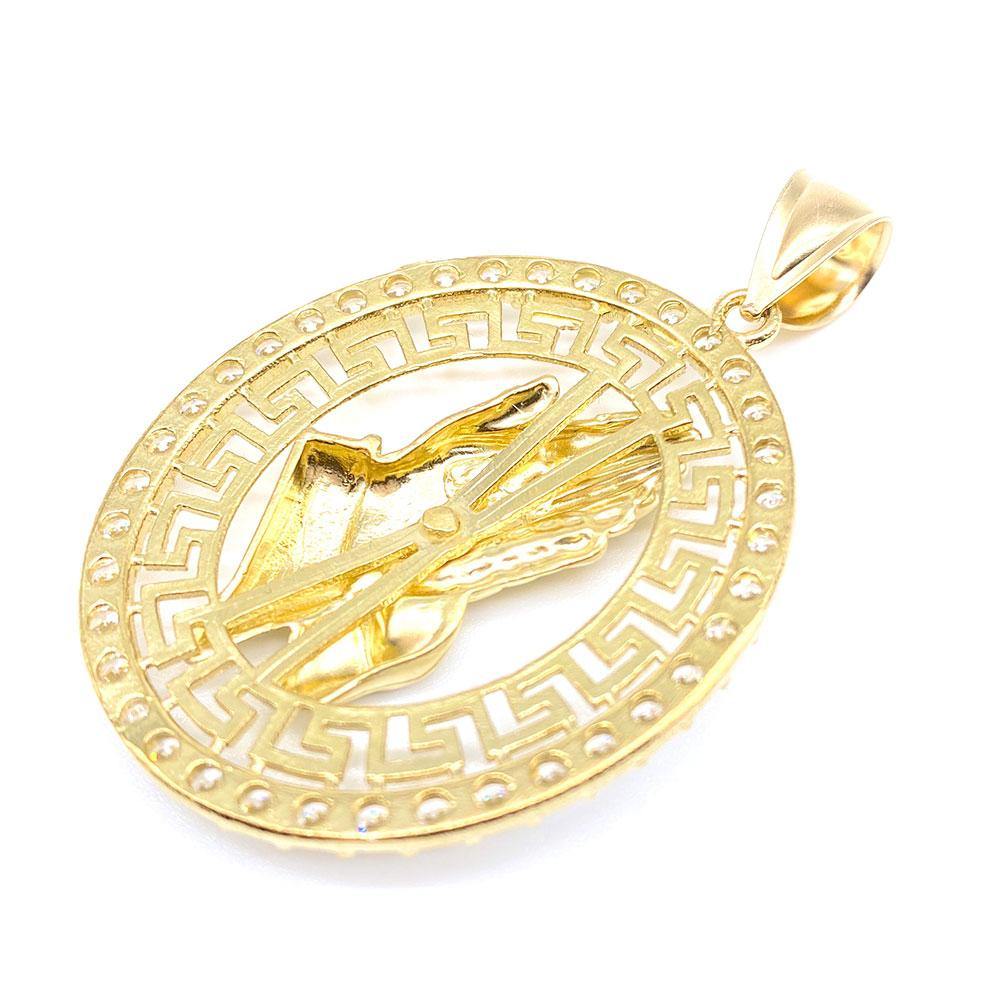 A 10k gold oval pendant featuring a cubic zirconia design of praying hands, surrounded by a geometric pattern. back